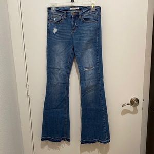 Mid rise flare jeans with raw hem